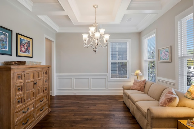 living area with a chandelier, dark wood-style flooring, coffered ceiling, visible vents, and wainscoting