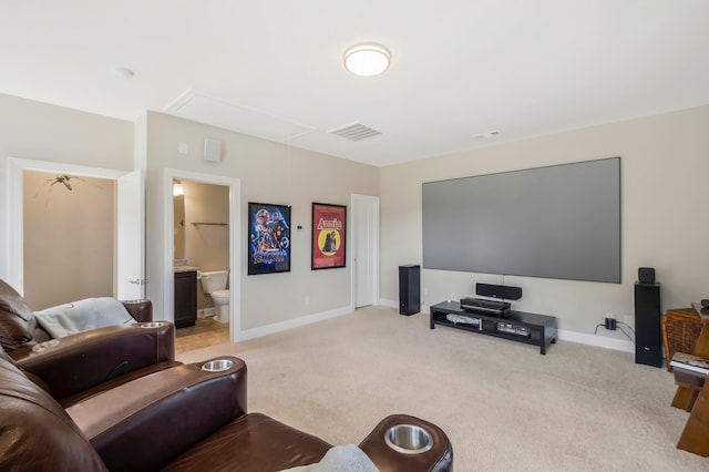 home theater featuring light carpet, visible vents, and baseboards