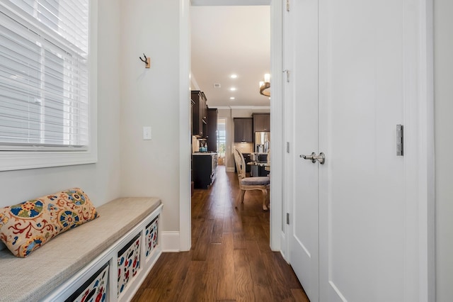 hall with dark wood-style floors, recessed lighting, baseboards, and crown molding