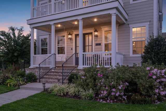 entrance to property with a balcony and covered porch