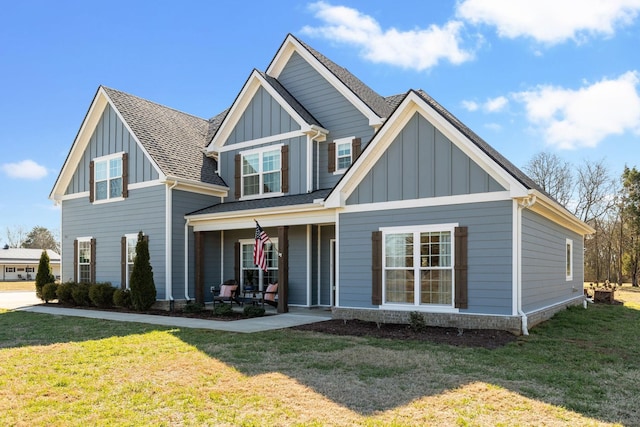 craftsman house featuring board and batten siding, a porch, a shingled roof, and a front lawn