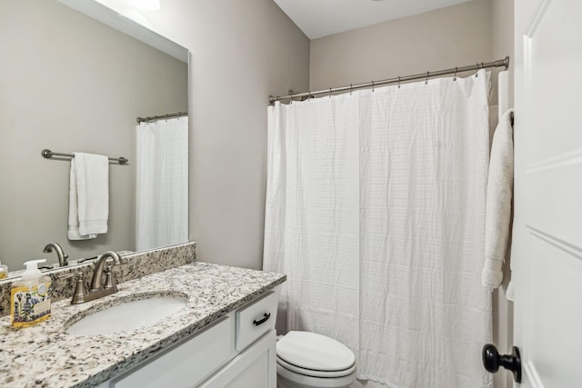 bathroom with vanity, toilet, and a shower with curtain