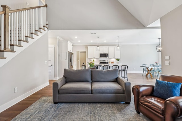 living room with recessed lighting, baseboards, stairs, ornamental molding, and dark wood-style floors