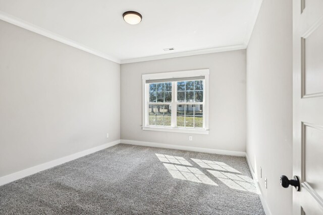 empty room featuring carpet floors, ornamental molding, visible vents, and baseboards