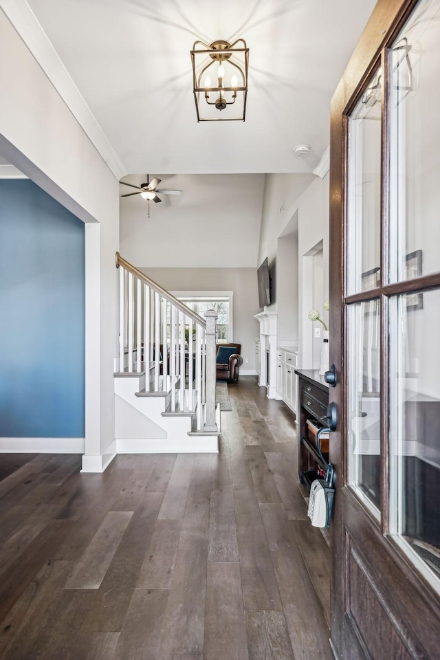 entryway featuring stairs, crown molding, dark wood-style floors, and baseboards