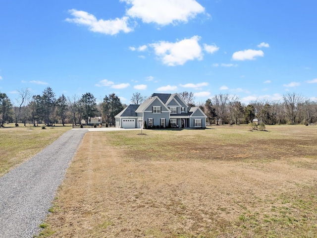 view of front of property with a garage, a front yard, and driveway