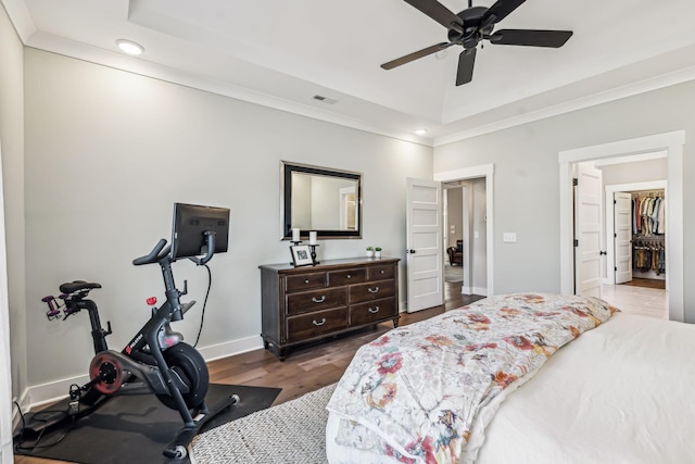 bedroom with recessed lighting, wood finished floors, visible vents, baseboards, and ornamental molding