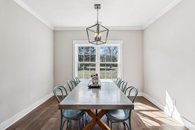 dining area featuring baseboards, ornamental molding, dark wood-style floors, and an inviting chandelier