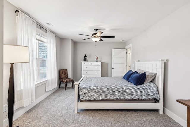 carpeted bedroom with baseboards, visible vents, and ceiling fan