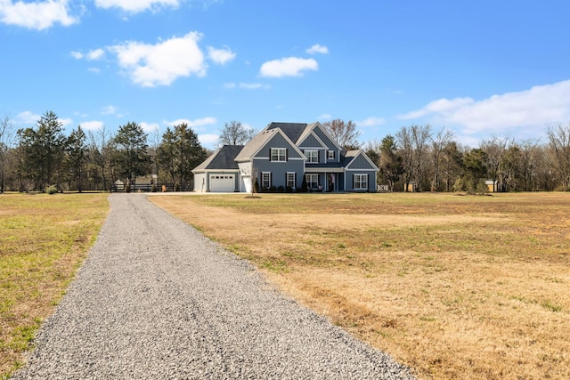 view of front of property featuring a garage, driveway, and a front yard