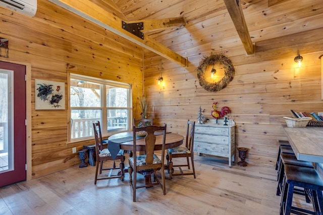 dining space with a wall unit AC, light wood-style floors, wood walls, wooden ceiling, and beamed ceiling