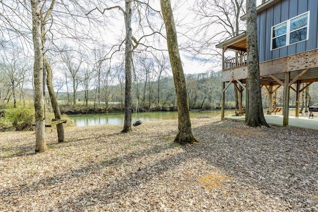 view of yard featuring a water view and a view of trees