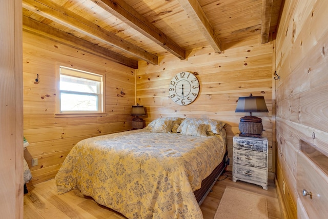 bedroom with wooden ceiling, beamed ceiling, wood walls, and light wood finished floors