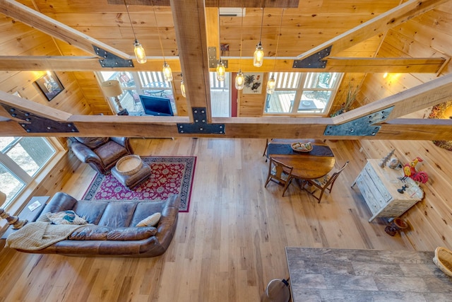 living area with high vaulted ceiling, beamed ceiling, wood finished floors, and wood ceiling