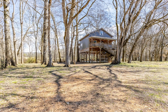 exterior space featuring covered porch and stairs