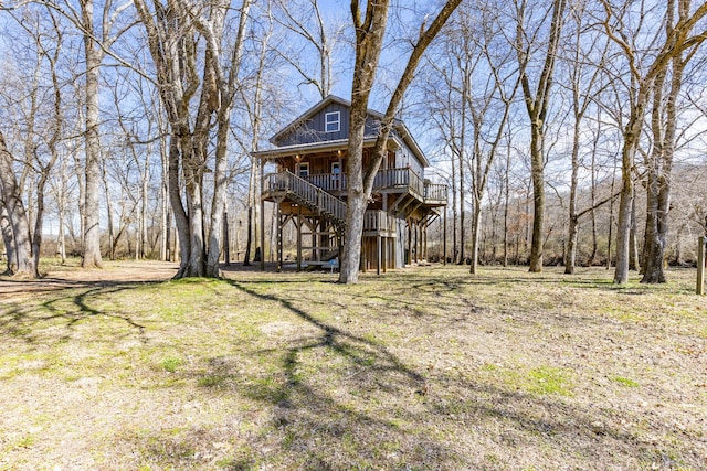 view of front of property with covered porch and stairs