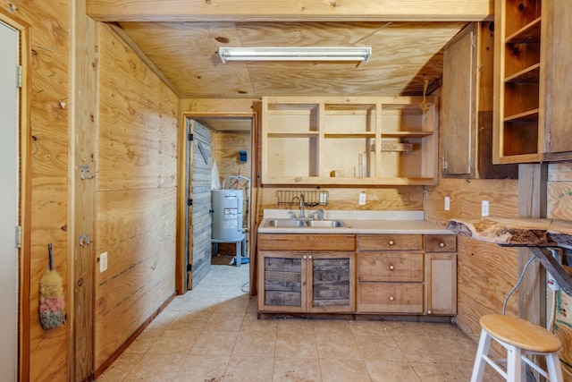 kitchen with brown cabinets, electric water heater, light countertops, open shelves, and a sink