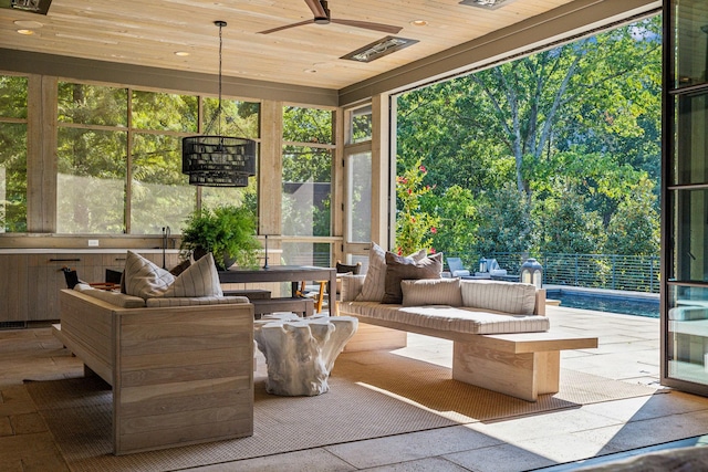 sunroom / solarium with wooden ceiling and a ceiling fan