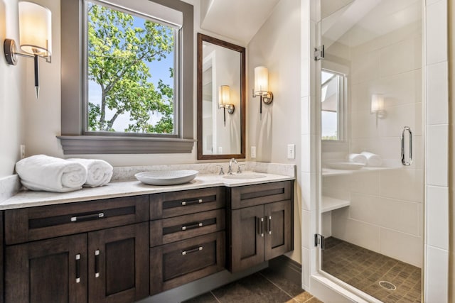 full bathroom with a shower stall, vanity, and tile patterned floors