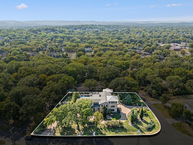 birds eye view of property with a wooded view