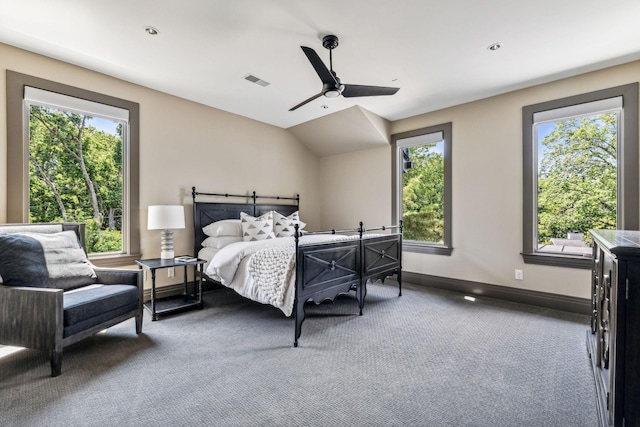 carpeted bedroom featuring baseboards, visible vents, vaulted ceiling, and a ceiling fan