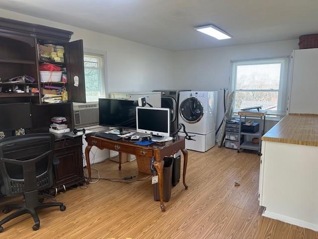 office space with a wealth of natural light, light wood-type flooring, and washer and clothes dryer