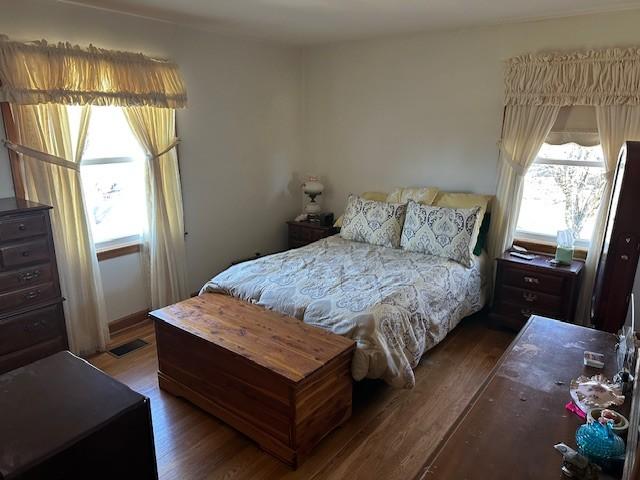 bedroom with wood finished floors and visible vents