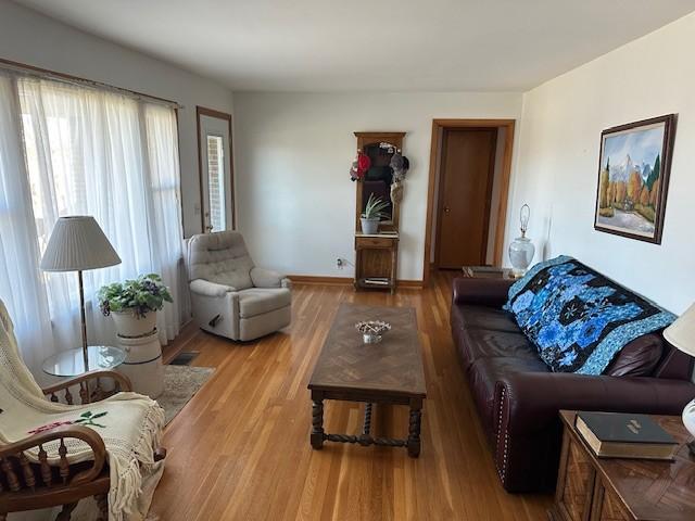 living room with wood finished floors and baseboards