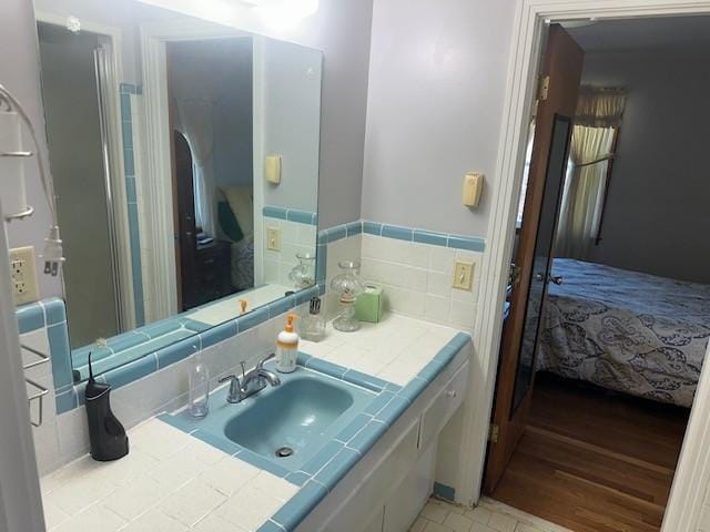 bathroom featuring vanity and ensuite bathroom