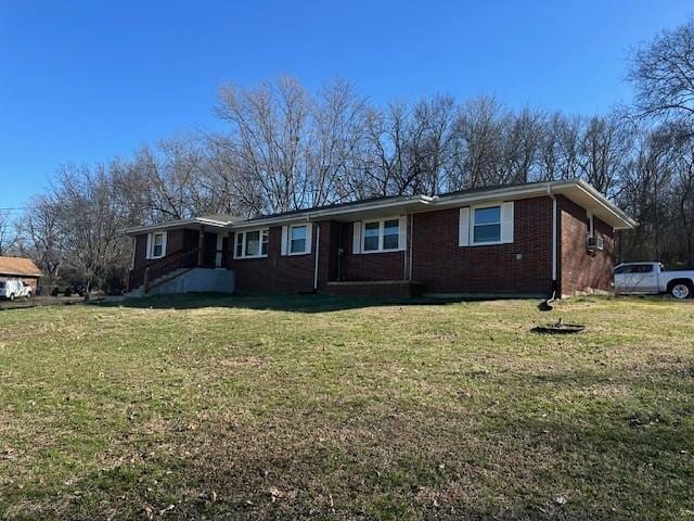 single story home with a front lawn and brick siding