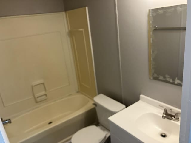 bathroom featuring bathtub / shower combination, vanity, and toilet