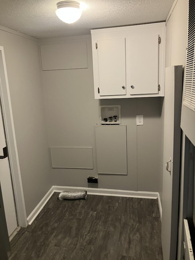 laundry area with washer hookup, cabinet space, a textured ceiling, wood finished floors, and baseboards