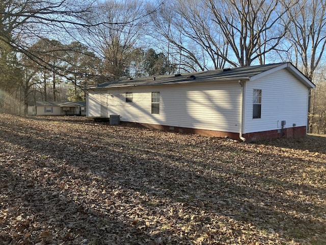 view of side of home featuring crawl space and central air condition unit