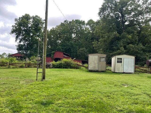 view of yard with an outbuilding and a storage shed