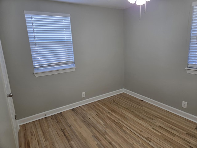 empty room with wood finished floors and baseboards