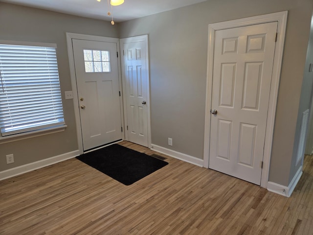 entryway featuring baseboards and light wood-style floors