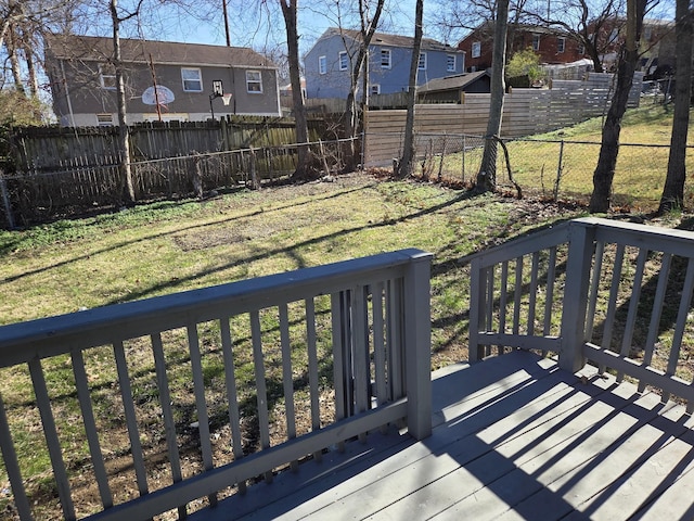 deck featuring fence private yard, a yard, and a residential view