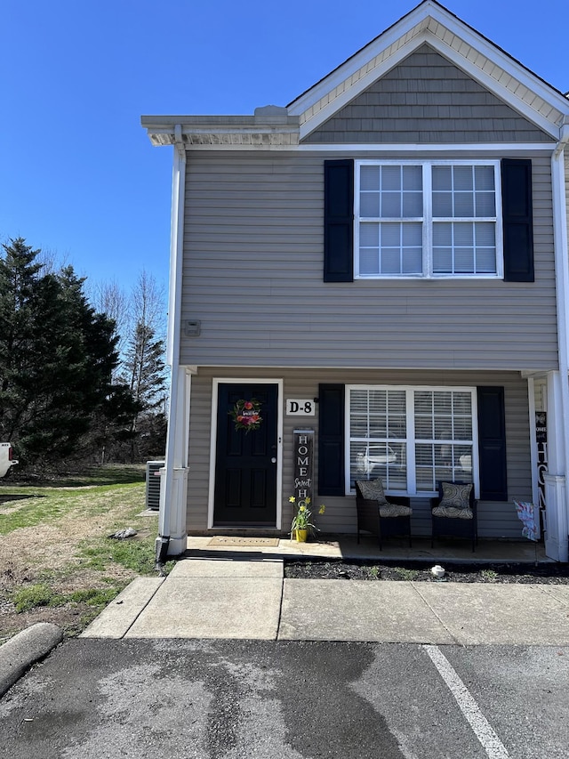 view of front of house with central AC unit and a porch