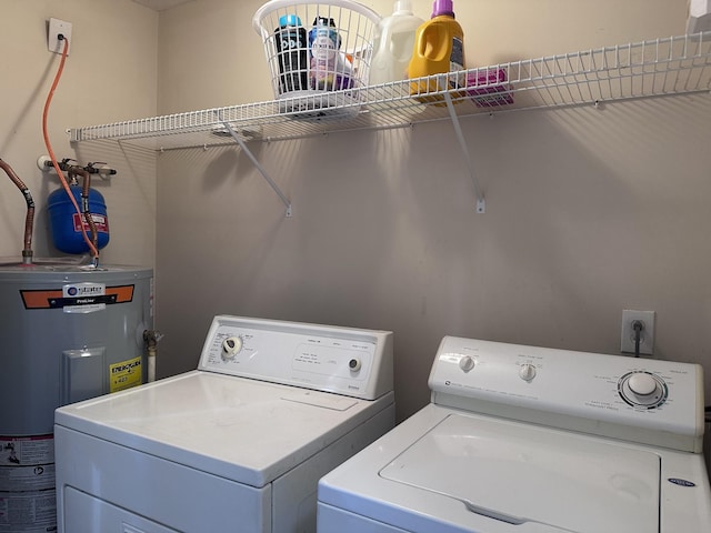 laundry area with laundry area, electric water heater, and independent washer and dryer