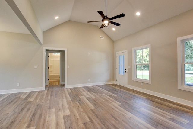 empty room with baseboards, a ceiling fan, light wood-type flooring, high vaulted ceiling, and recessed lighting