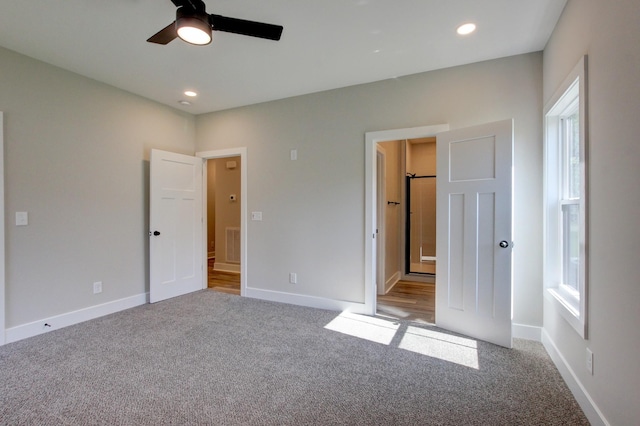 unfurnished bedroom featuring carpet floors, visible vents, and baseboards