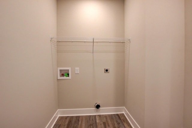 washroom featuring hookup for a washing machine, dark wood-type flooring, electric dryer hookup, laundry area, and baseboards