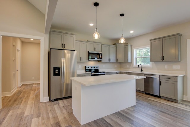 kitchen with gray cabinets, stainless steel appliances, and a sink