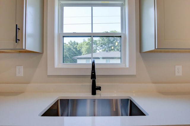 interior details featuring light countertops and a sink