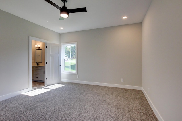 unfurnished bedroom with baseboards, recessed lighting, ensuite bathroom, and light colored carpet