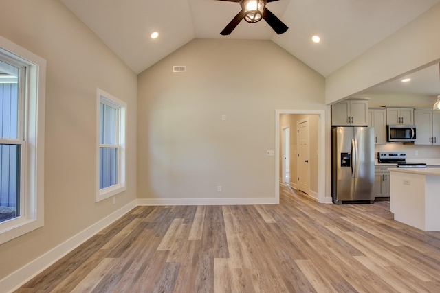 kitchen featuring light countertops, appliances with stainless steel finishes, light wood-style flooring, and visible vents