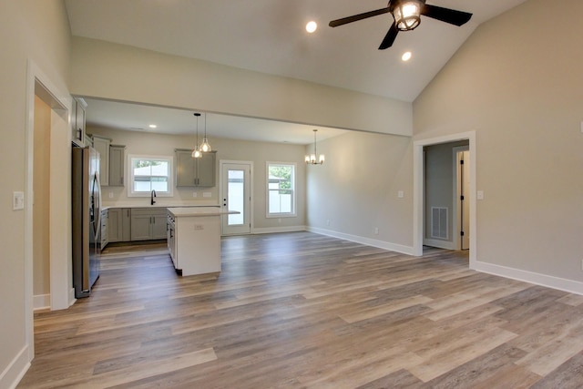 kitchen featuring visible vents, baseboards, gray cabinets, freestanding refrigerator, and light wood finished floors