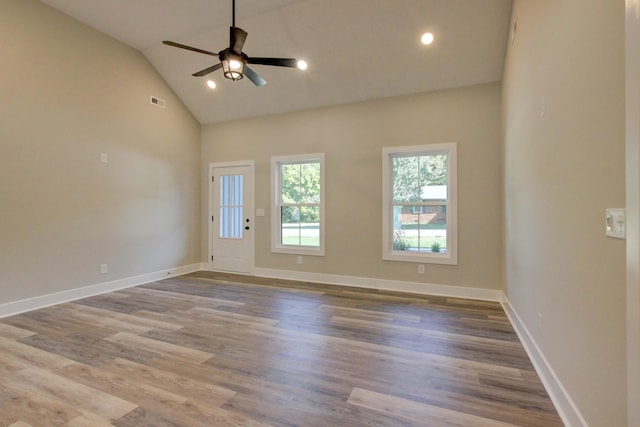 unfurnished room with vaulted ceiling, wood finished floors, a ceiling fan, and baseboards