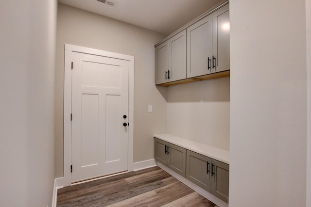 mudroom featuring baseboards and light wood-style floors