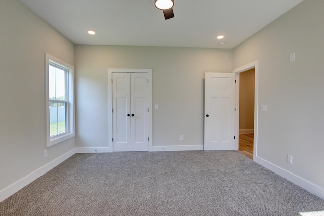 unfurnished bedroom featuring carpet, baseboards, and recessed lighting